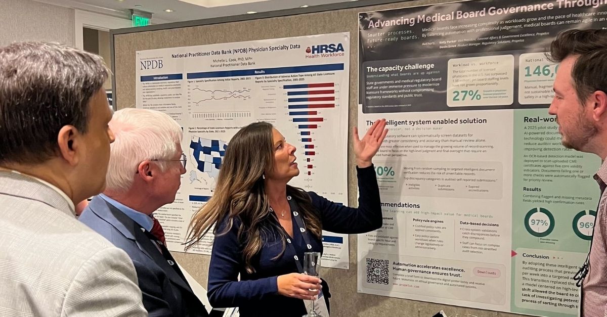 Kelly Parker gestures toward a conference poster at the FSMB Annual Meeting.