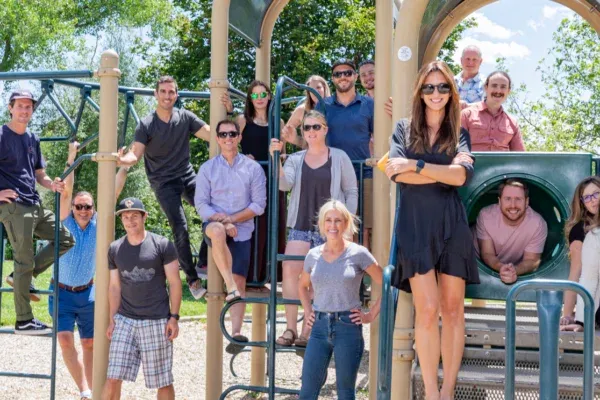 Employees smiling at a park