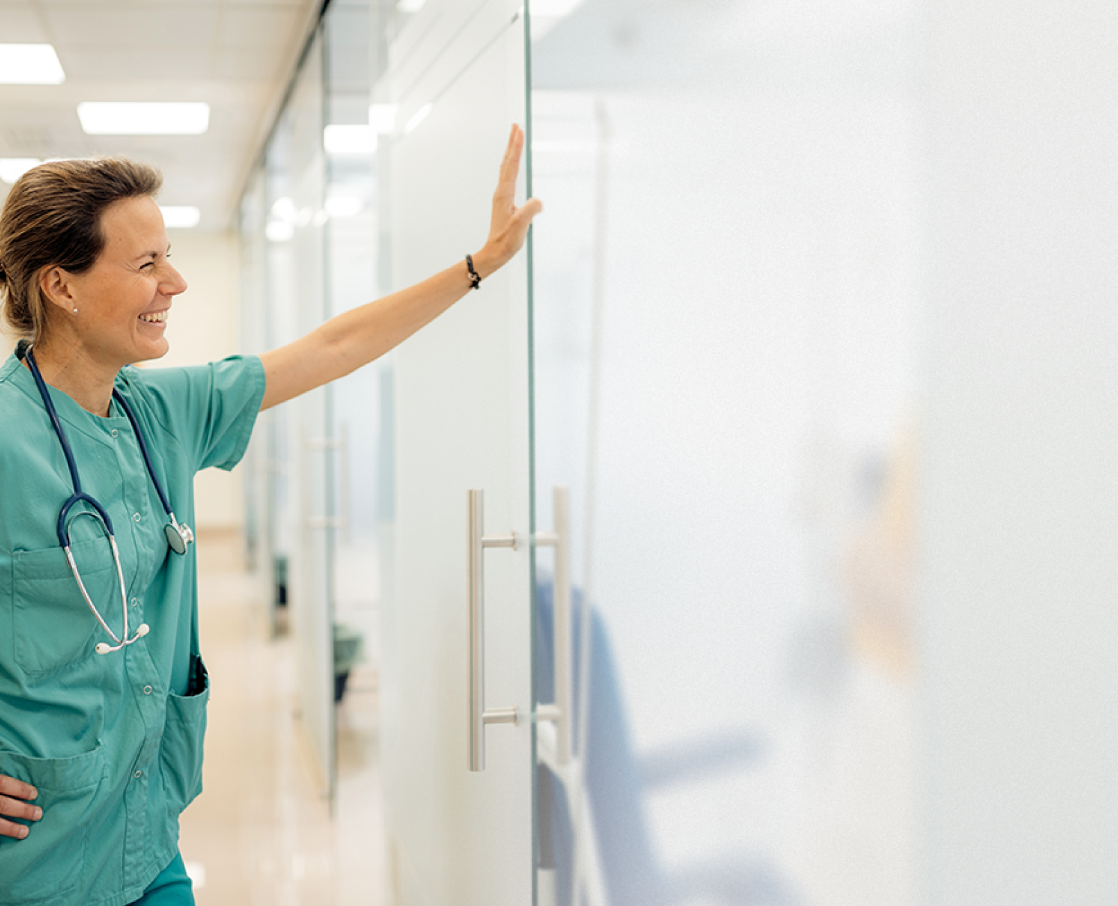 Woman in scrubs smiling