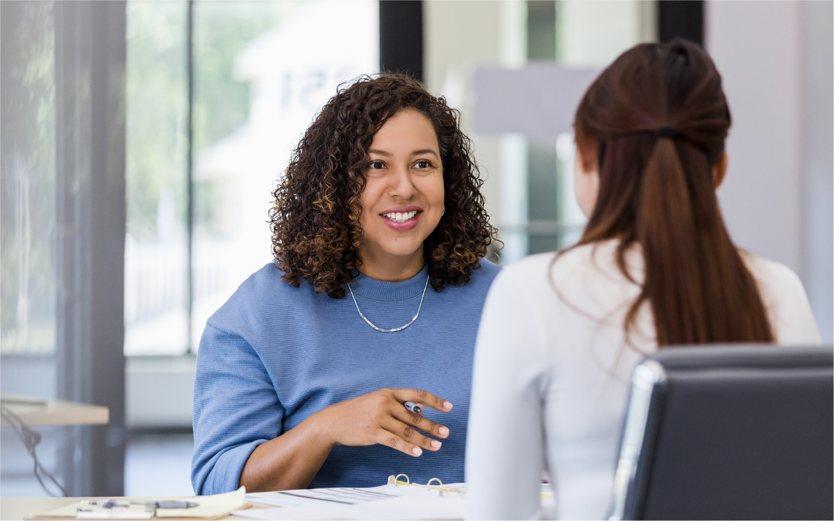 HR professional meeting with a colleague across a desk