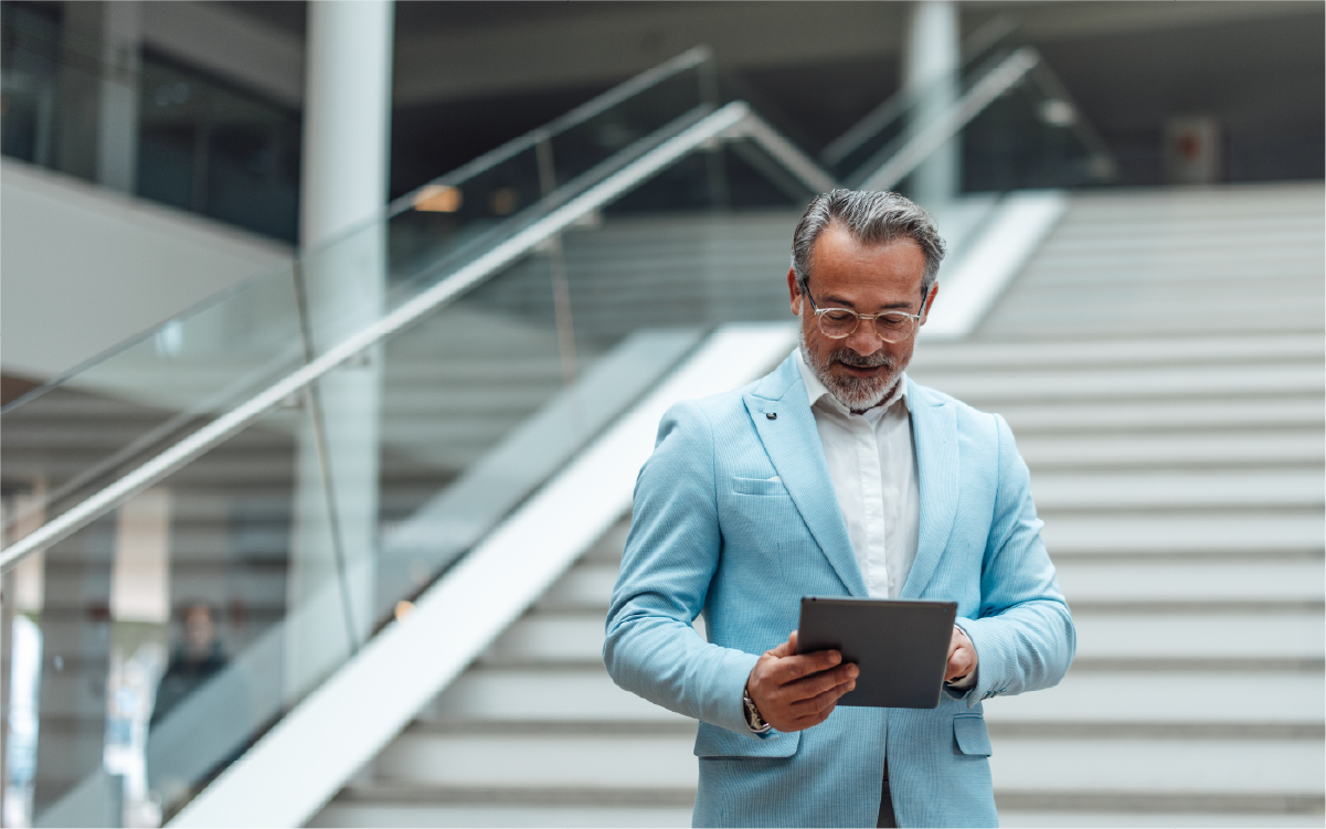 Health system leader reviewing compliance dashboards on a tablet