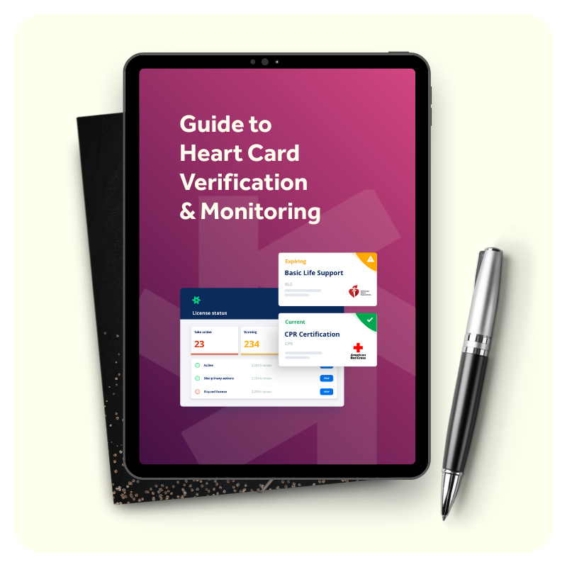 Tablet displaying a guide to heart card verification and monitoring, showing a dashboard with license status, certification cards including Basic Life Support and CPR Certification from the American Red Cross, placed on a black notebook with a pen beside it